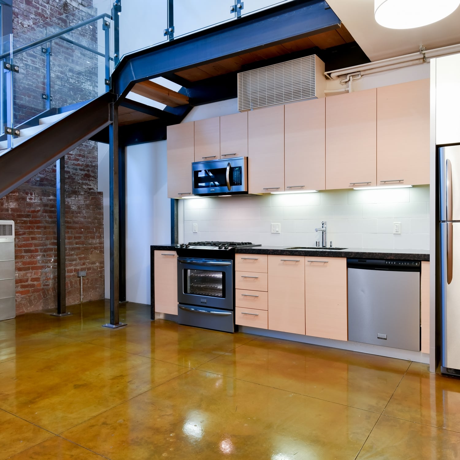 Apartments South Park-Industrial Style Kitchen With Modern Cabinets and Stainless Appliances